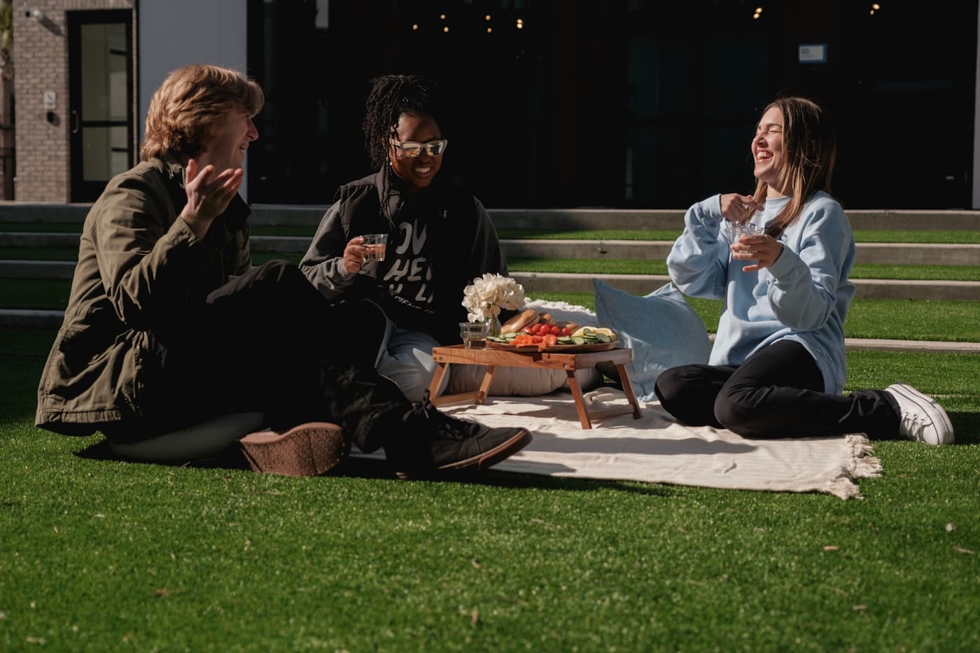 Friends laughing together during an outdoor gathering